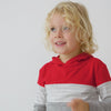 video of a child wearing a candy red colorblock hooded tee and coordinating bottoms