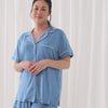 Video of a woman wearing and demonstrating a Heather Blue women's short sleeve and shorts pajama set