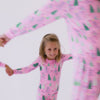 Video of a family wearing matching Pink Twinkling Trees pajamas