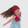 Video of a child wearing a Candy Red Stripes flutter tee with coordinating overalls and luxe bow headband