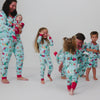 Family of six wearing matching Disney & Pixar Christmas Village pajamas