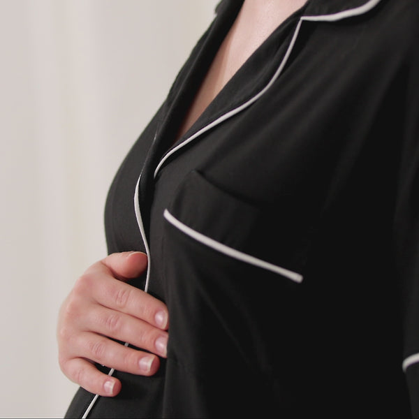 Video of women wearing and demonstrating Black women's short sleeve and shorts pajama set