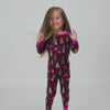 Jumping child wearing the Cranberry Tree Traffic Holiday Pajama Set