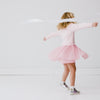 video of smiling girl playing with streamer and twirling while wearing the Rosy Swan Crewneck Tutu Dress