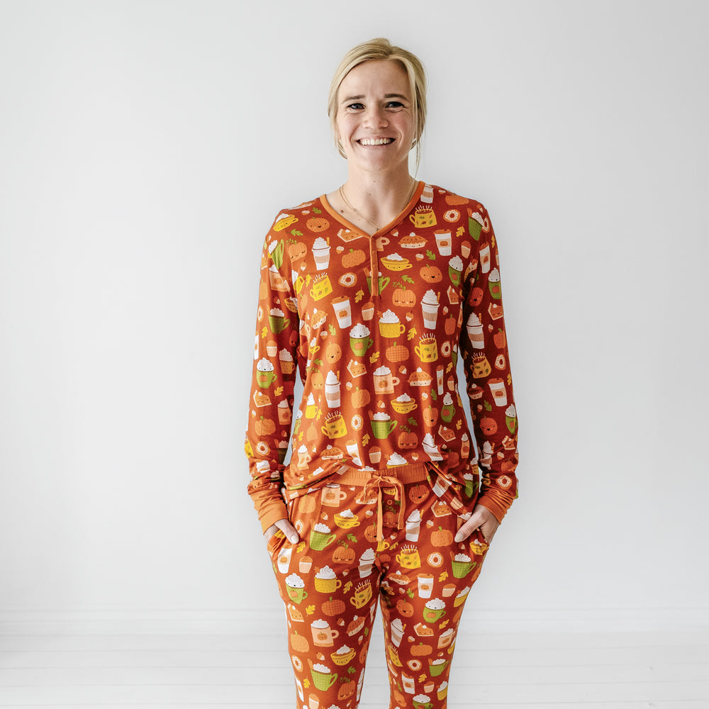 Woman wearing a Pumpkin Spice women's pajama top and matching pajama pants