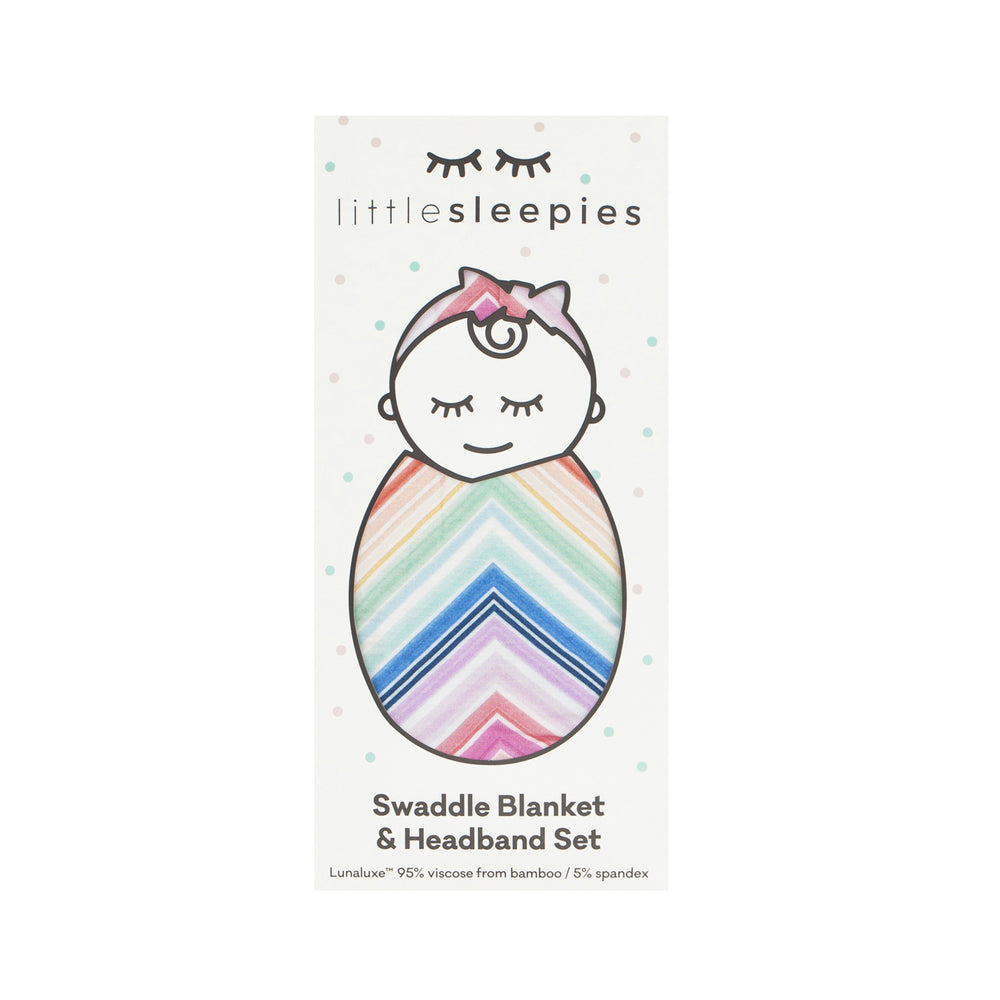 Flat lay image of a Rainbow Chevron printed swaddle and luxe bow set in Little Sleepies peek-a-boo packaging