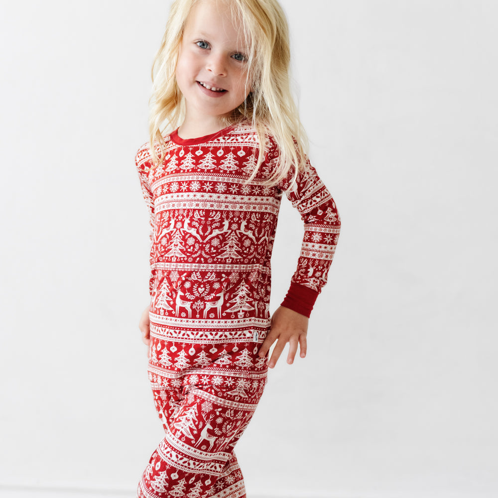 Alternate image of a child posing wearing a Reindeer Cheer two piece pajama set
