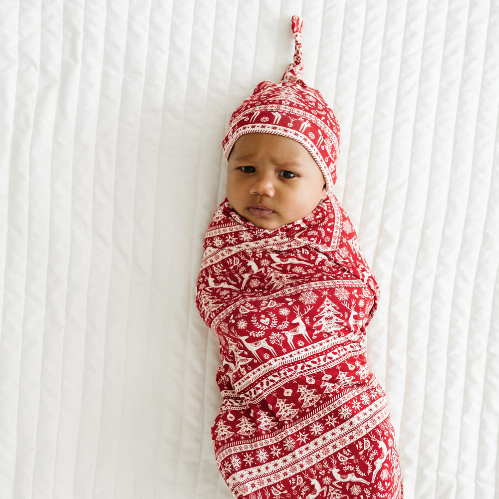 Alternative image of a child swaddled on a bed in a Reindeer Cheer swaddle and hat set
