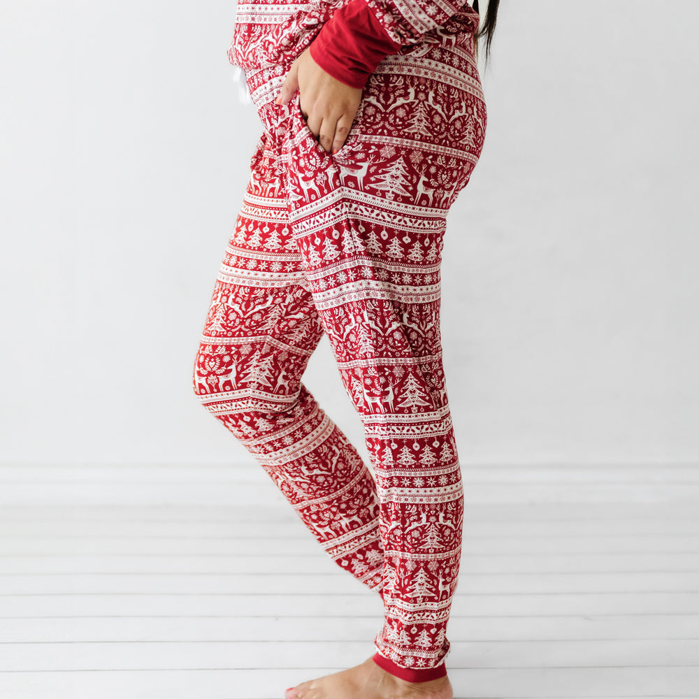 Profile view of a woman wearing Reindeer Cheer women's pajama pants