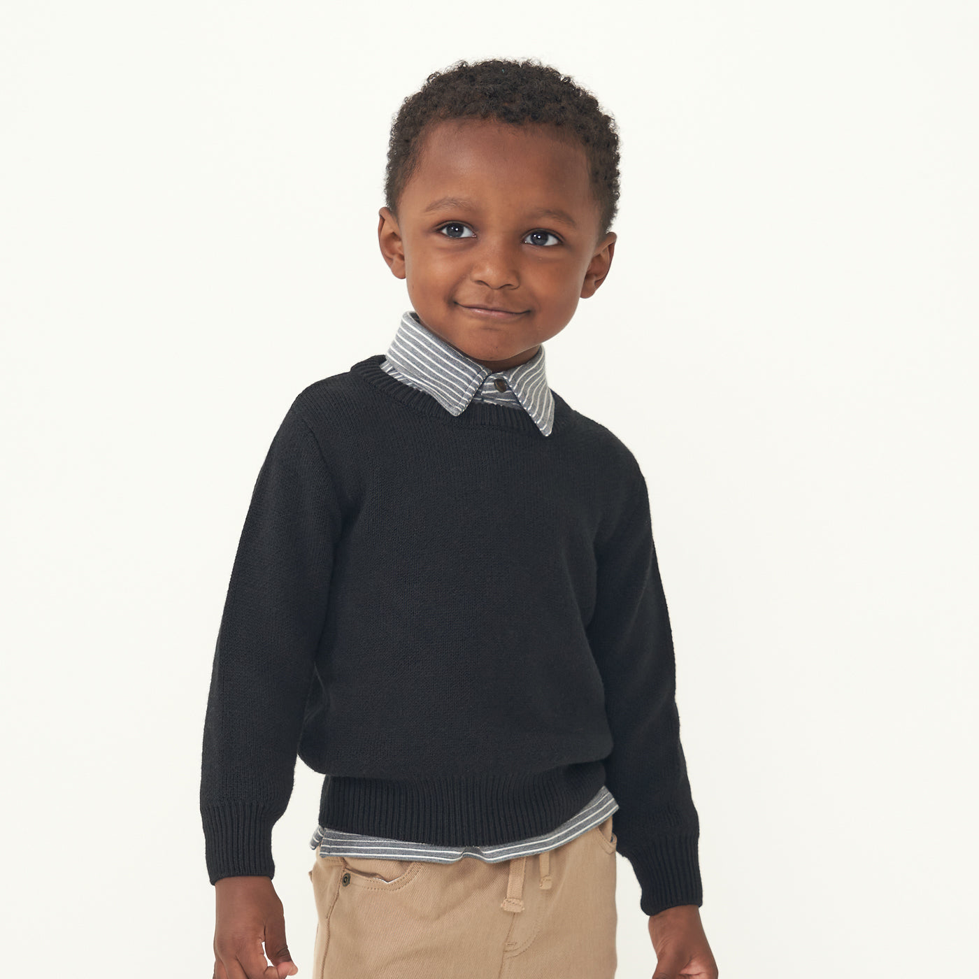 Child wearing a Black knit sweater and coordinating Heather Charcoal Stripes polo shirt