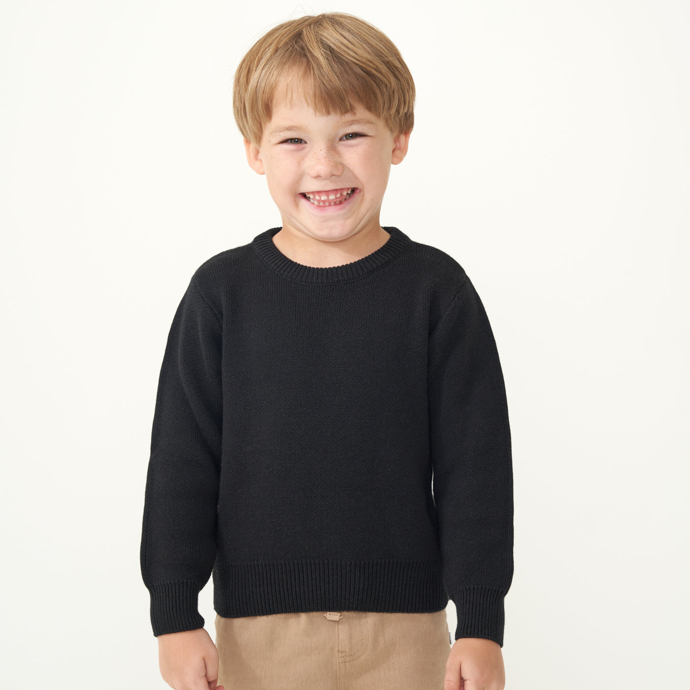 Child wearing a Black knit sweater