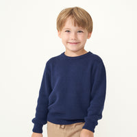 Child wearing a Classic Navy knit sweater