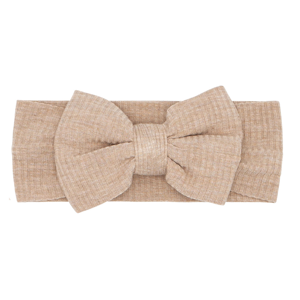 Flat lay image of a Heather Fawn ribbed luxe bow headband 