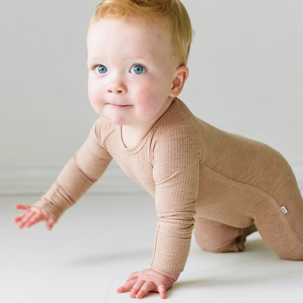 Child crawling wearing a Heather Fawn Ribbed Crescent Zippy