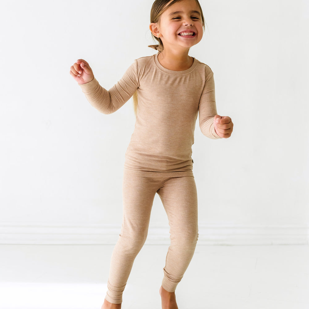 Child wearing a Heather Fawn ribbed two piece pajama set