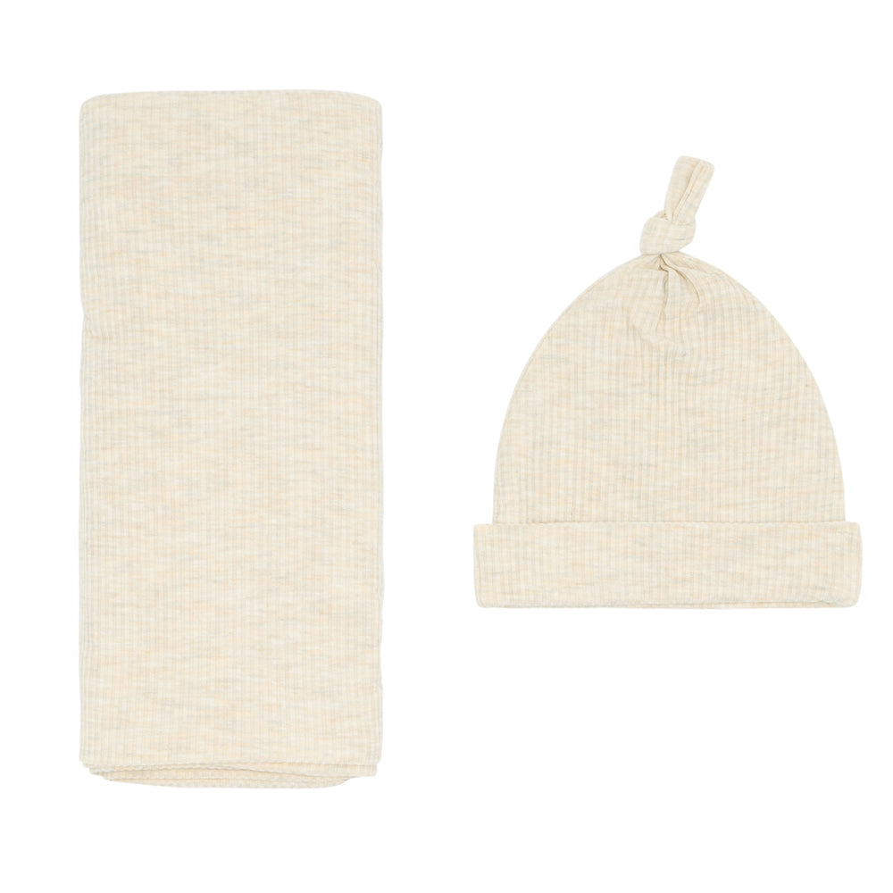 Flat lay image of a Heather Oatmeal Ribbed swaddle and hat set