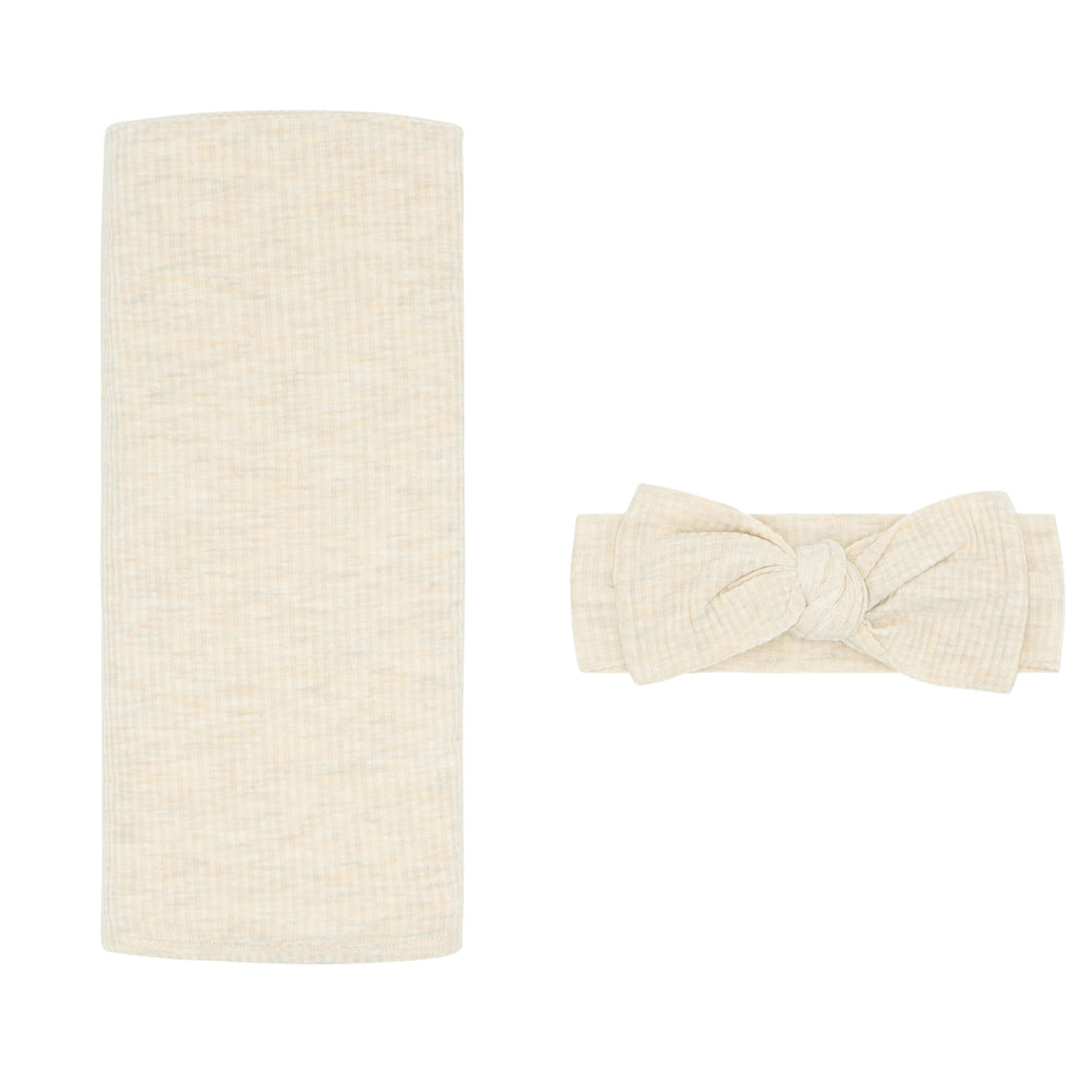 Flat lay image of a Heather Oatmeal Ribbed swaddle and luxe headband set