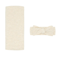 Flat lay image of a Heather Oatmeal Ribbed swaddle and luxe headband set