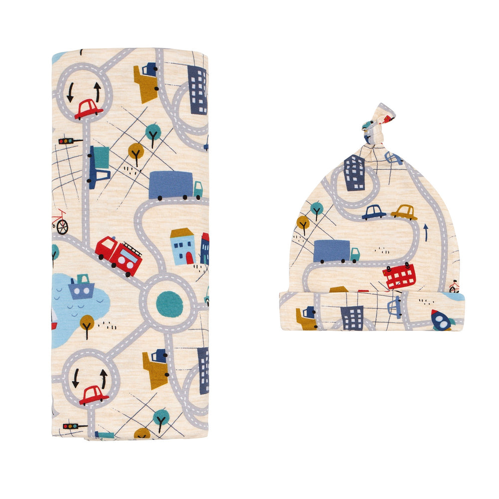Click to see full screen - Flat lay image of a Blue Road Trip swaddle and hat set