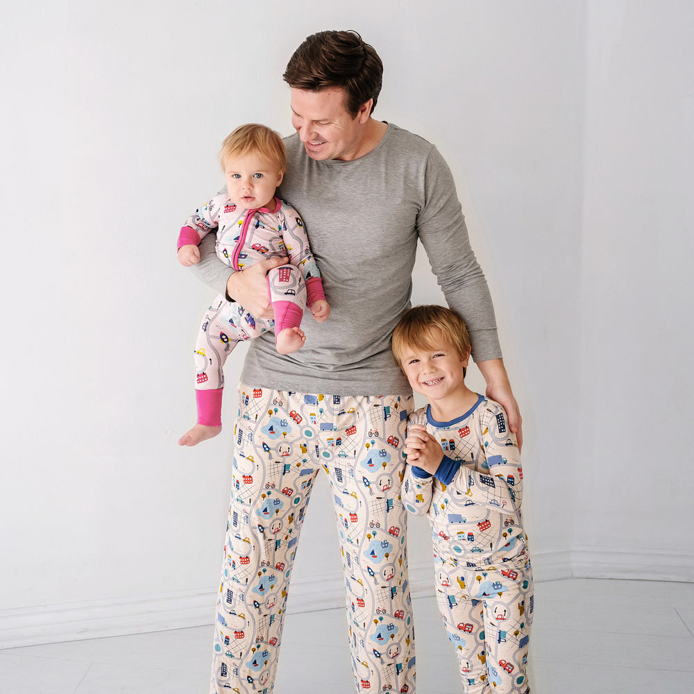 Click to see full screen - Father and his two children wearing matching Road Trip pajamas. Dad is wearing men's Blue Road Trip pajama pants and solid Heather Gray men's pajama top. Children are wearing Blue and Rosy Road Trip pjs in two piece and zippy styles