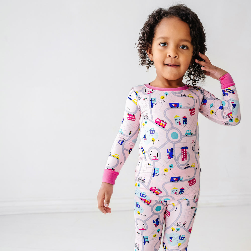 Click to see full screen - Alternate close up image of a child wearing a Rosy Road Trip two piece pajama set