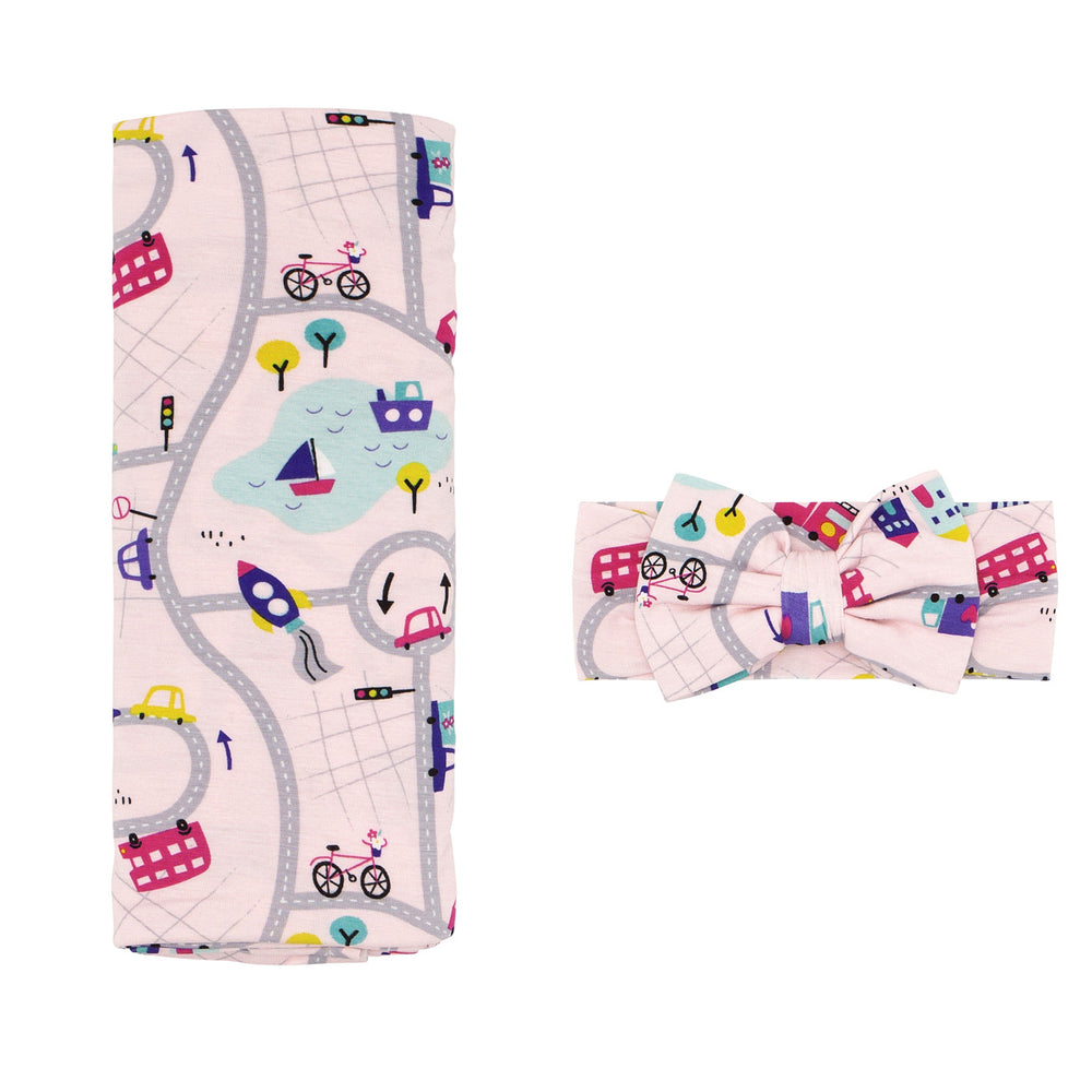 Click to see full screen - Flat lay image of a Rosy Road Trip swaddle and luxe bow headband set