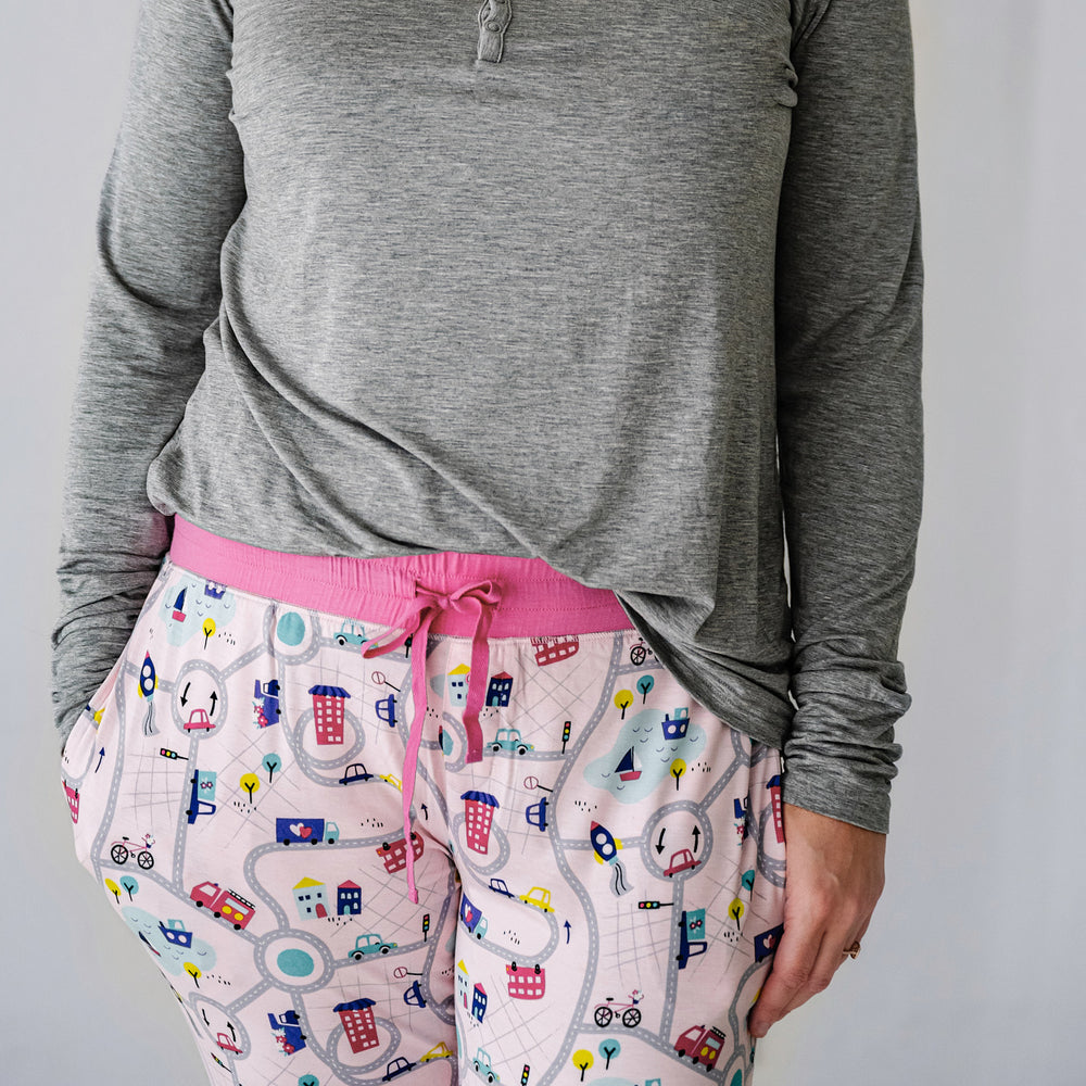 Click to see full screen - Close up image of a woman's waistband. She's wearing Rosy Road Trip women's pj pants and a Heather Gray women's pajama top