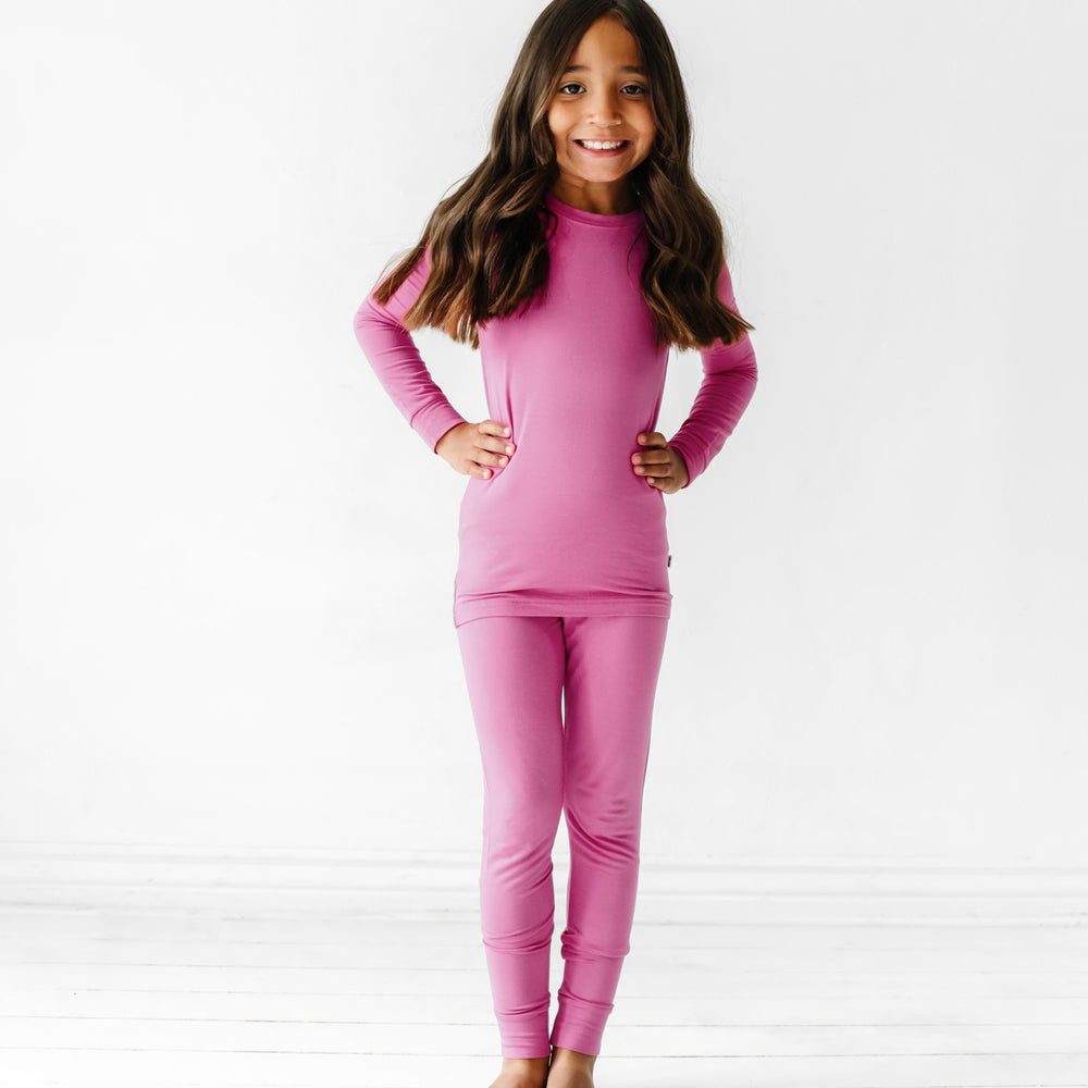Child posing wearing a Rosette two piece pajama set