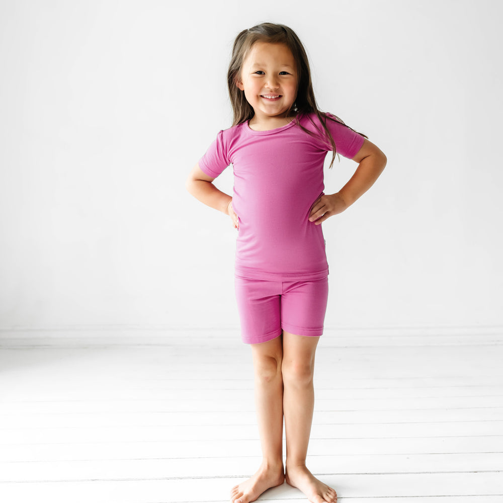 Child posing wearing a Rosette two piece short sleeve and shorts pajama set