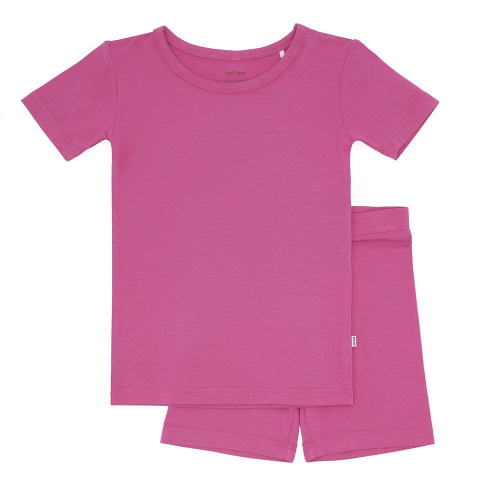 Click to see full screen - Flat lay image of a Rosette two piece short sleeve and shorts pajama set