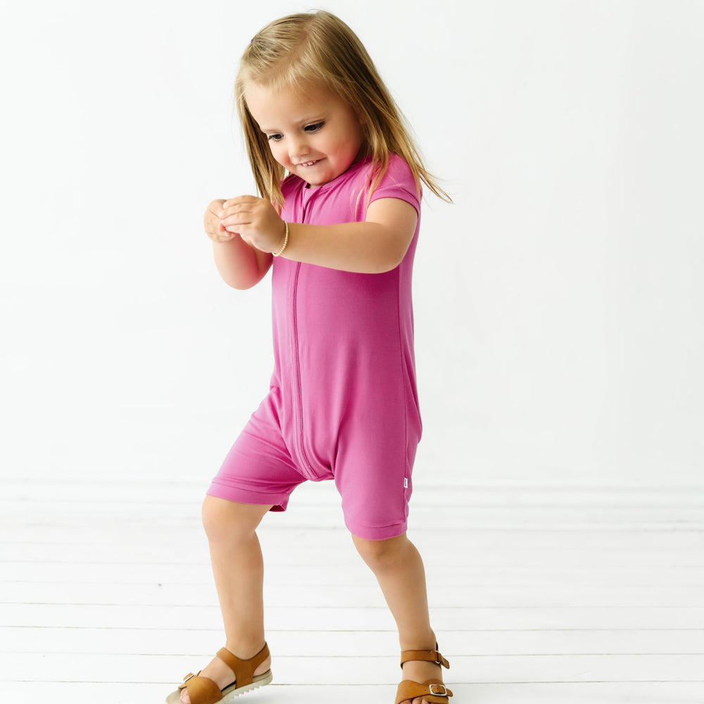 Child playing wearing a Rosette shorty romper