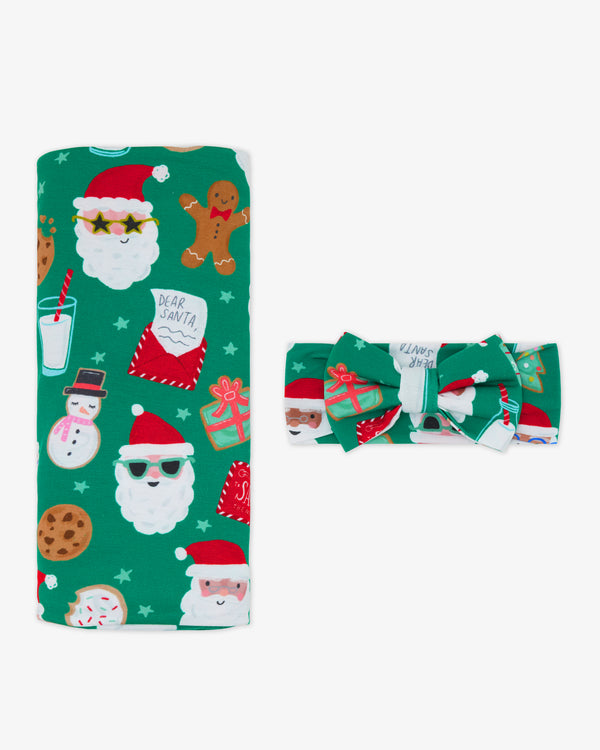 Flat lay of the Cookies for Santa Swaddle & Luxe Bow Headband Set