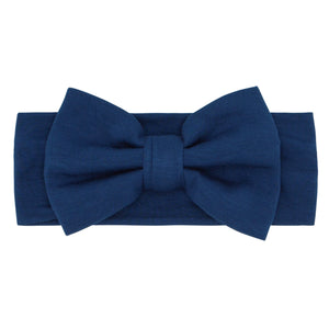 Flat lay image of a size Newborn to 3T Sapphire luxe bow headband