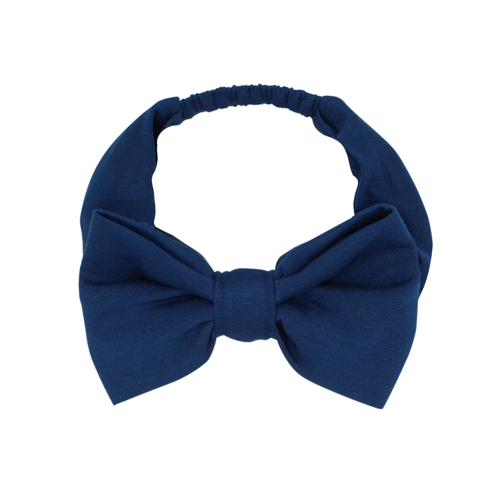 Flat lay image of an Age 4 to Age 8 Sapphire luxe bow headband