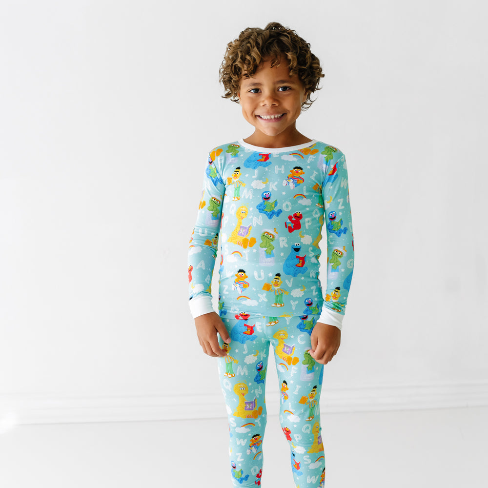 Child wearing a Spelling with Sesame Street two piece pajama set