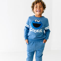 Child wearing a Sesame Street Cookie Monster crewneck sweatshirt and jogger set