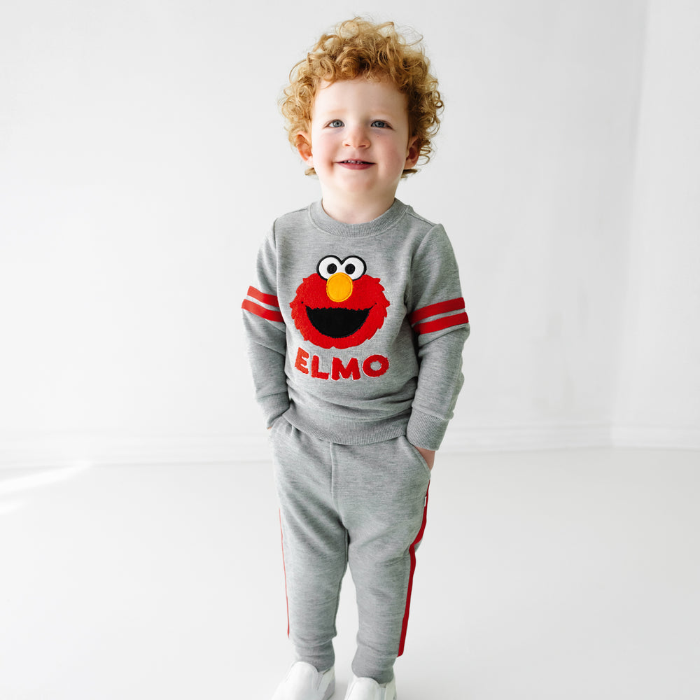 Child wearing a Sesame Street Elmo crewneck sweatshirt and jogger set