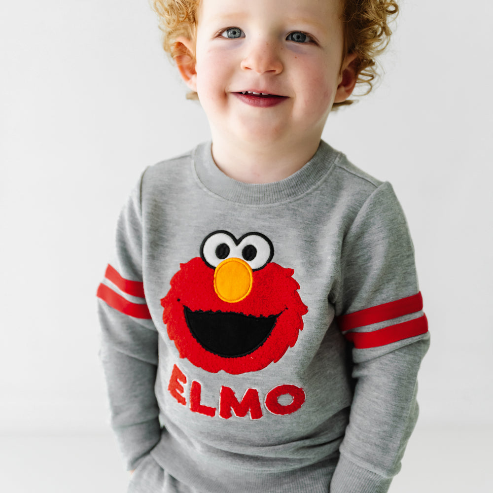 Alternate close up image of a child wearing a Sesame Street Elmo crewneck sweatshirt and jogger set
