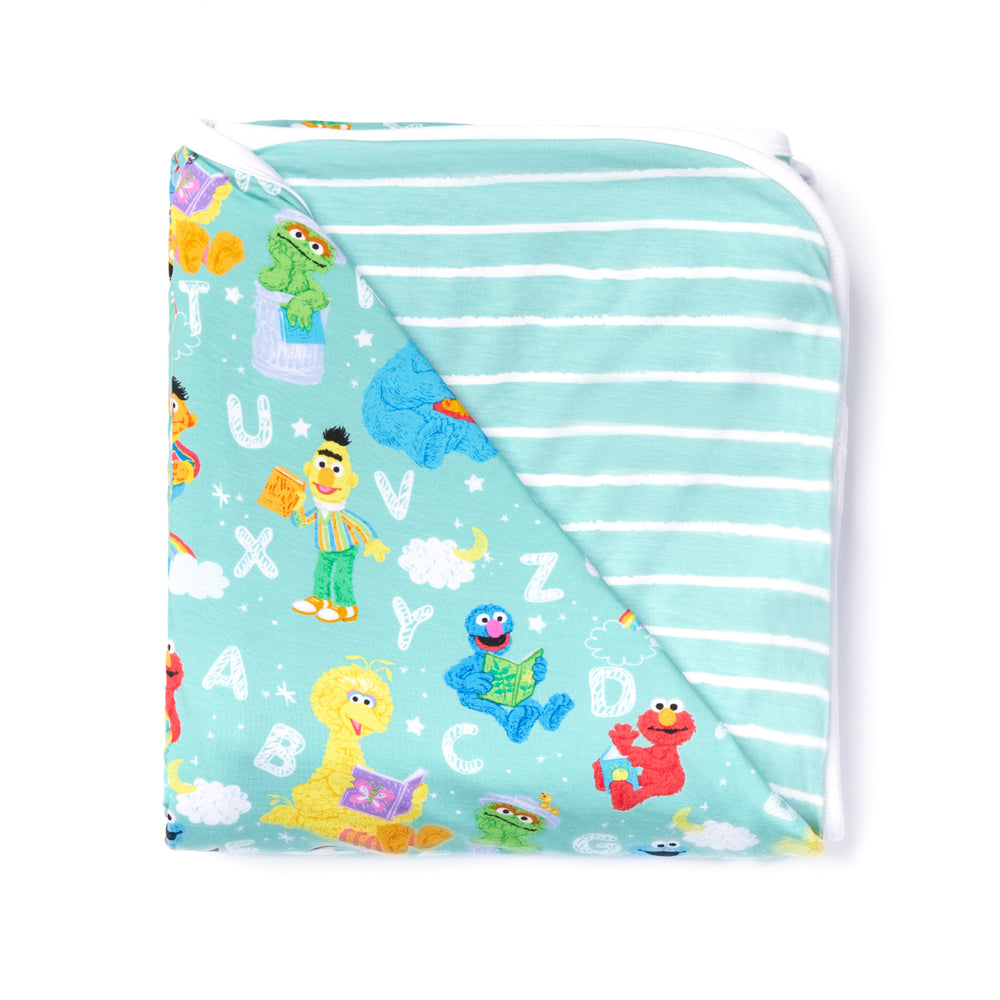 Flat lay image of a Spelling with Sesame Street large cloud blanket
