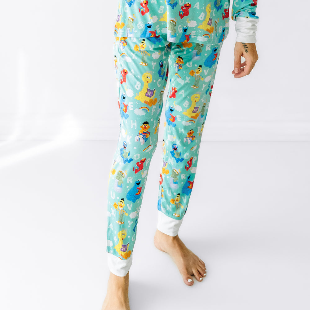 Close up image of a woman wearing Spelling with Sesame Street women's pajama pants