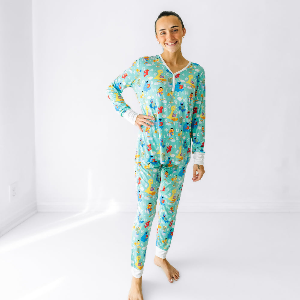 Woman wearing Spelling with Sesame Street women's pajama pants and matching top