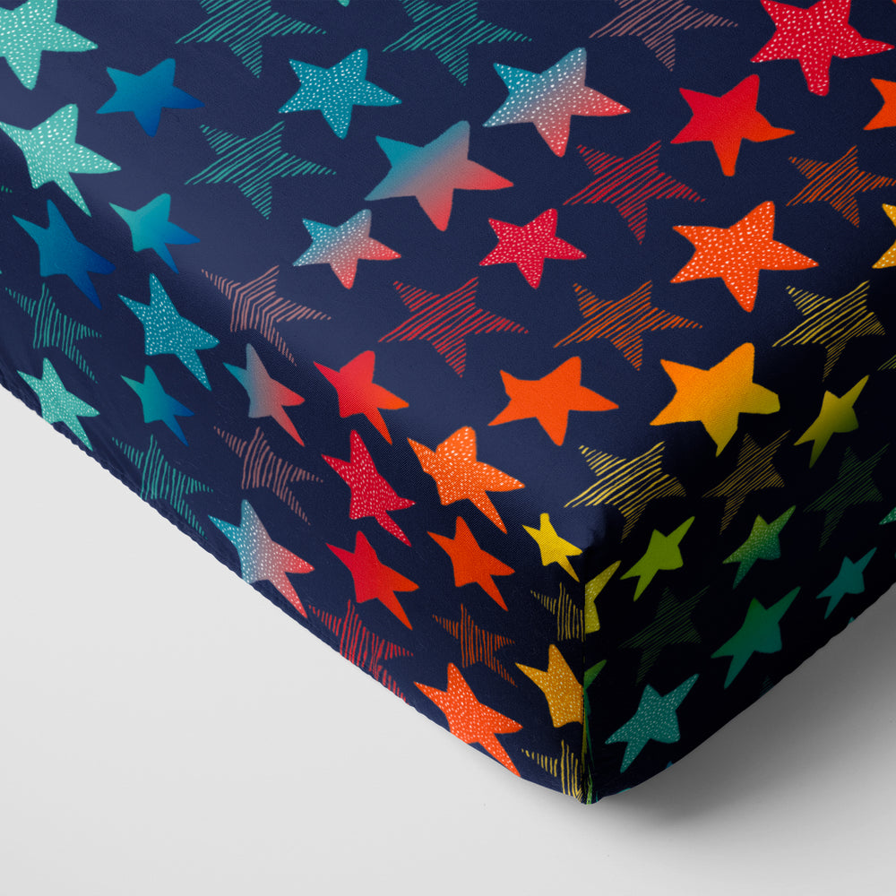 Click to see full screen - Corner view of Shades of Stars fitted crib sheet
