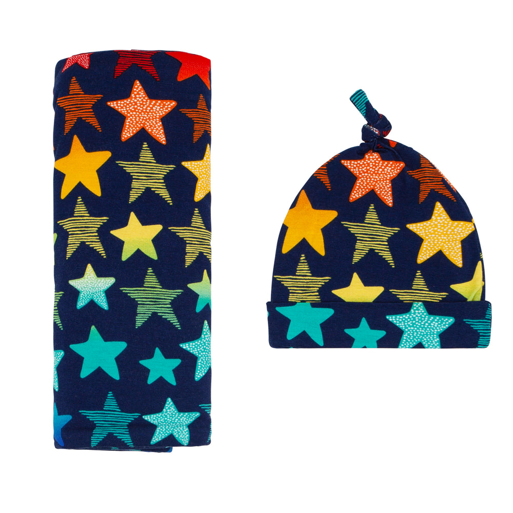 Click to see full screen - Flat lay image of a Shades of Stars swaddle & hat set
