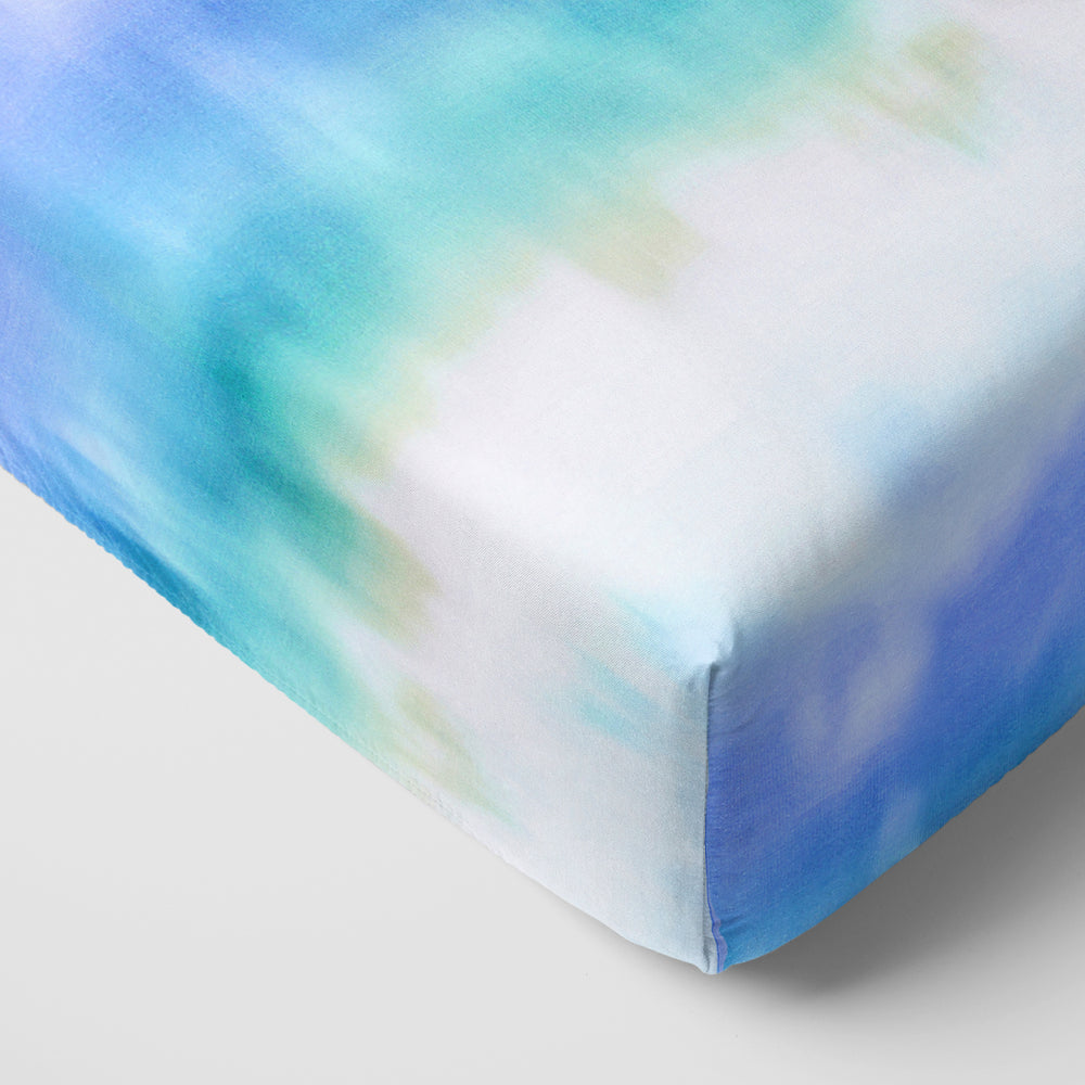 Close up of the corner of the Blue Cosmic Mist Fitted Crib Sheet