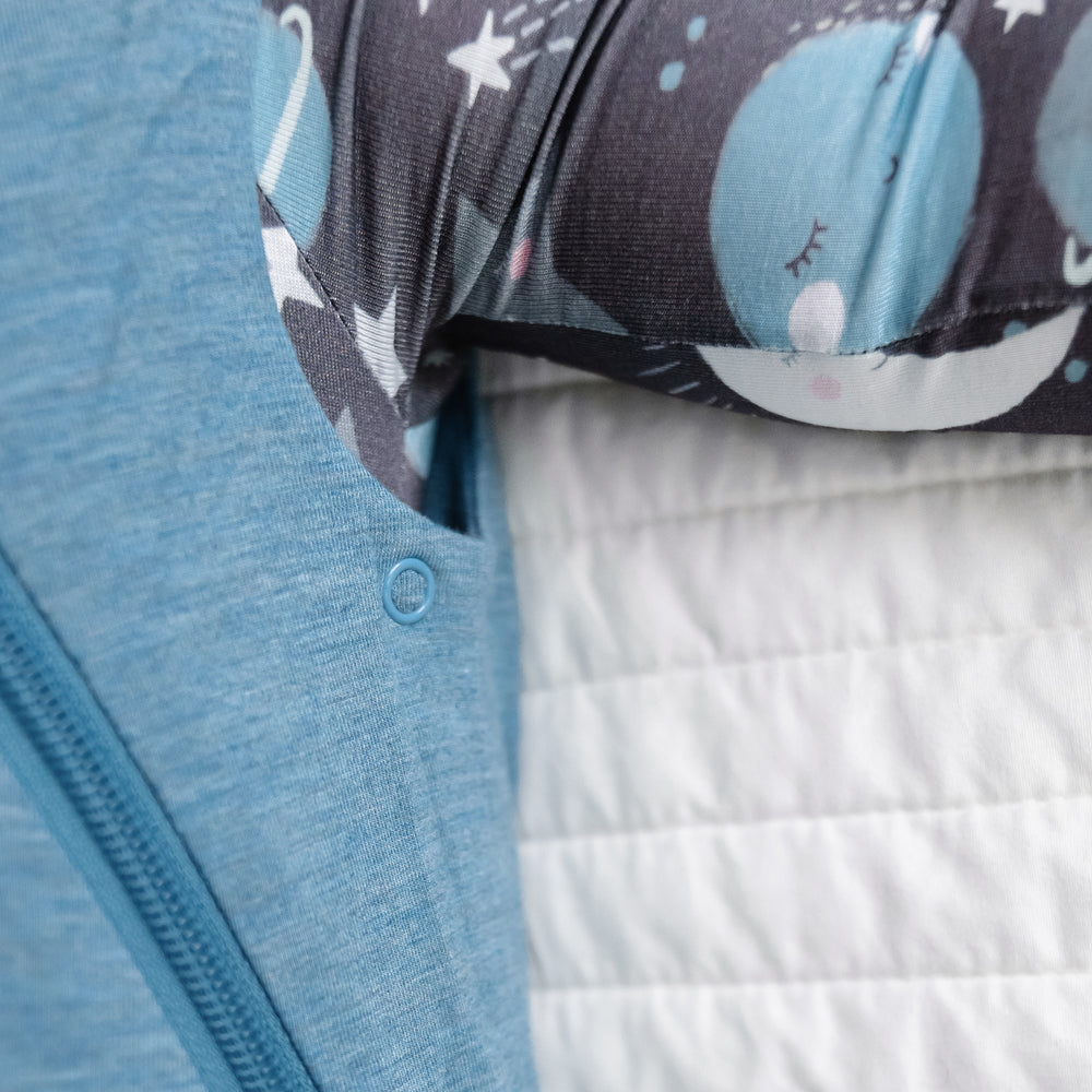 Click to see full screen - Alternate close up image of a child wearing a Heather Blue Sleepy Bag detailing the adjustable arm snaps