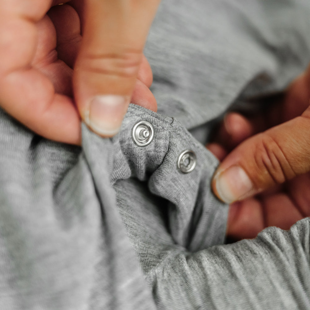 Click to see full screen - Close up image of a Heather Gray Sleepy bag detailing the adjustable arm snaps
