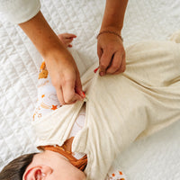 Alternate image of a child wearing a Heather Oatmeal sleepy bag with a parent zipping it up