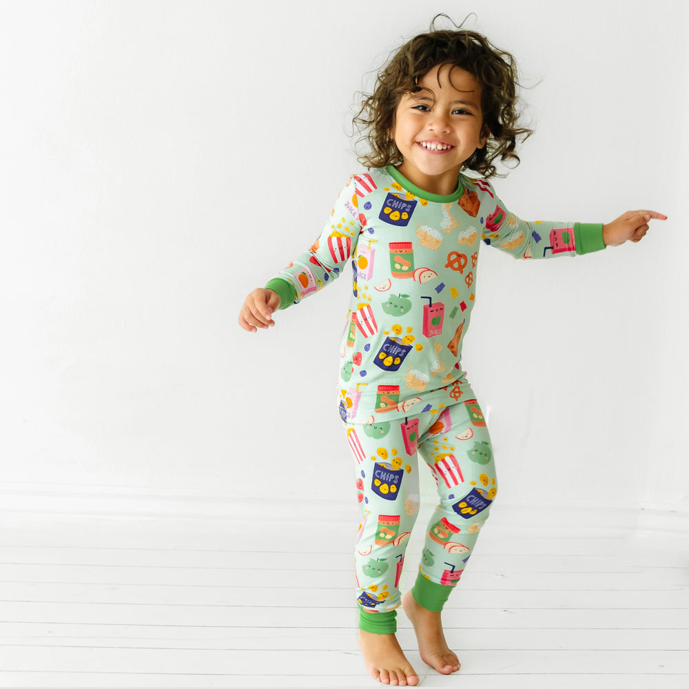 Child dancing wearing a Snack Attack two piece pajama set