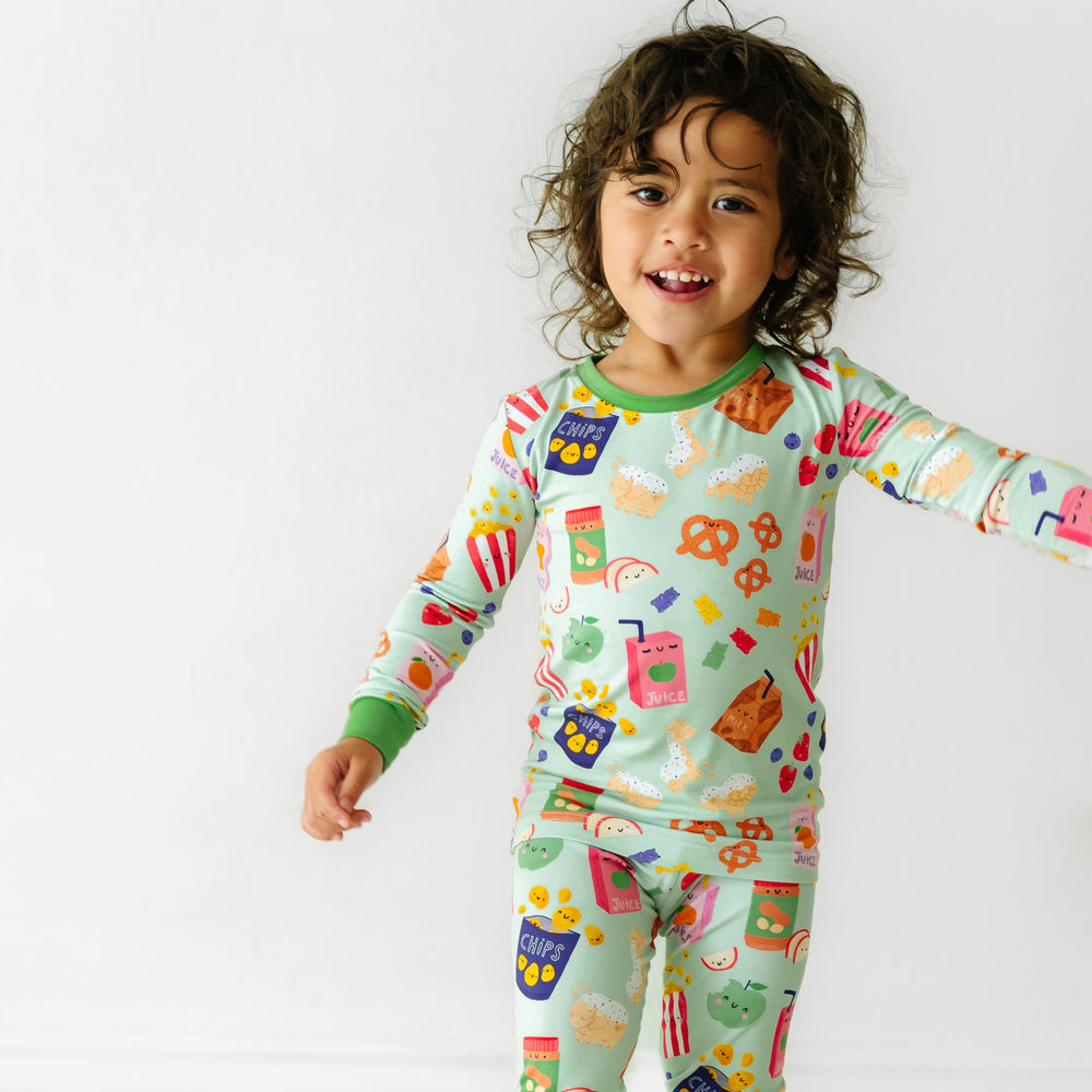 Close up image of a child wearing a Snack Attack two piece pajama set
