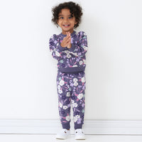 Alternate image of a child wearing Sugar Plum Floral joggers pared with a matching crewneck sweatshirt